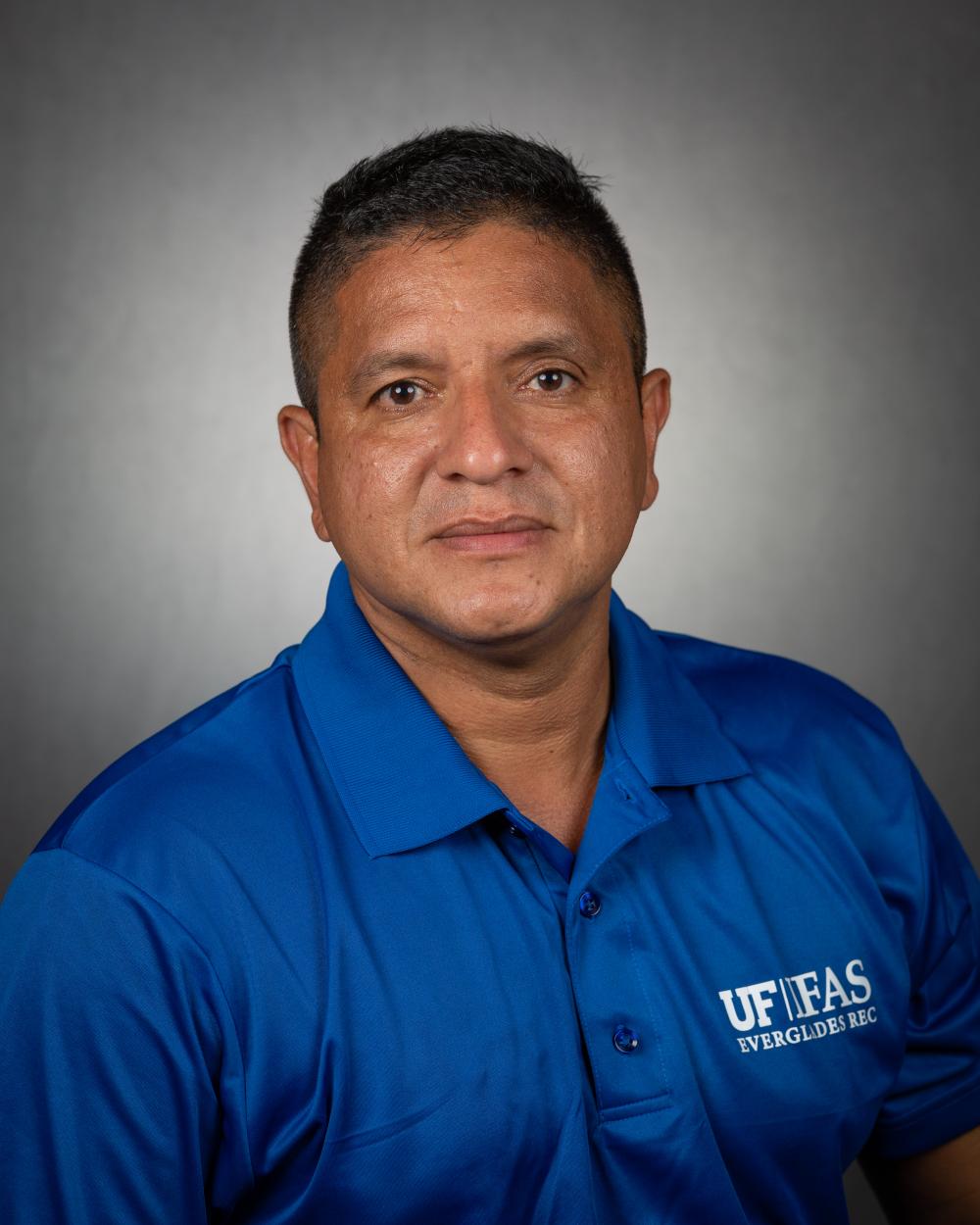 a smiling man in a blue shirt